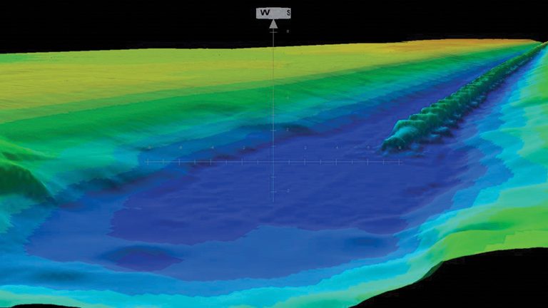Harrowside pipe in trench - Courtesy of Land & Marine