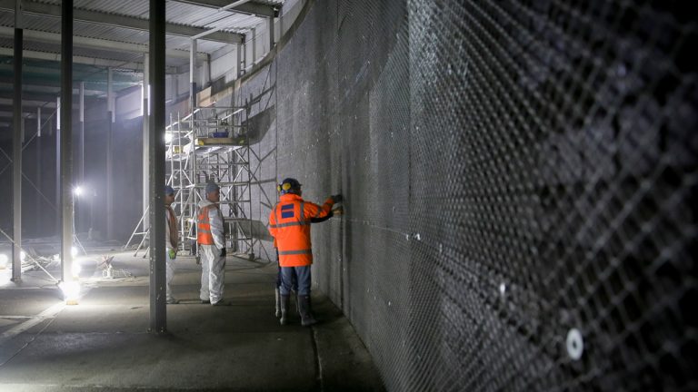 Applying concrete spray to mesh - Courtesy of Stonbury
