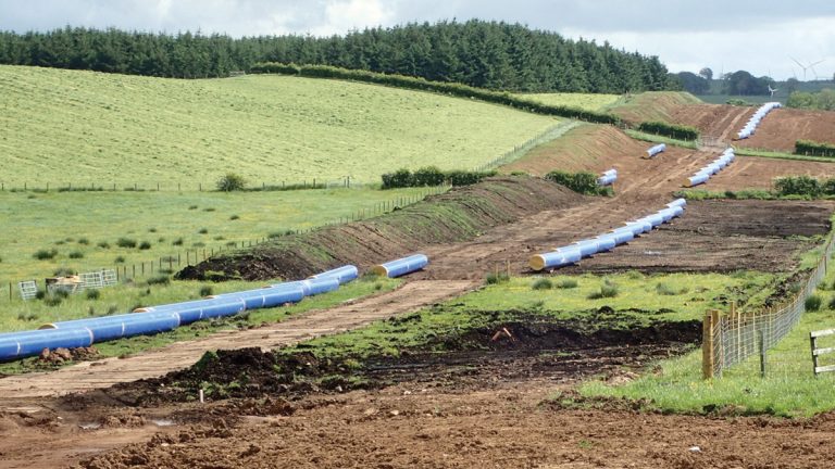 Pipes laid out awaiting welding - Courtesy of Caledonia Water Alliance