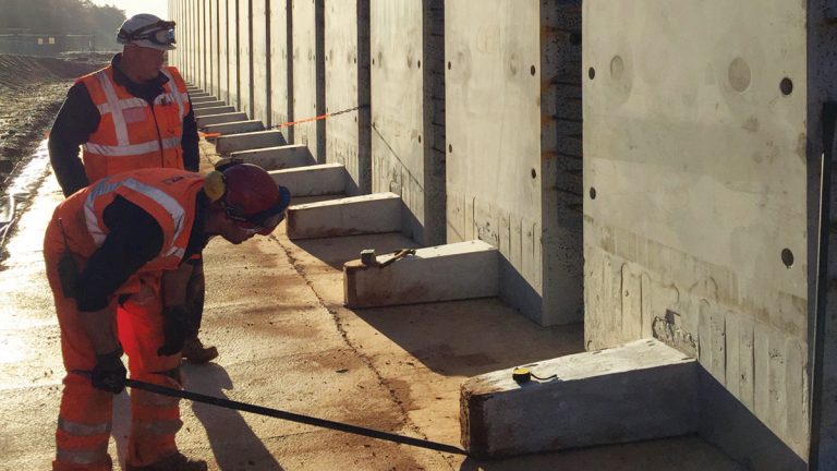 Precision placement of precast concrete wall units on site - Courtesy of MMB