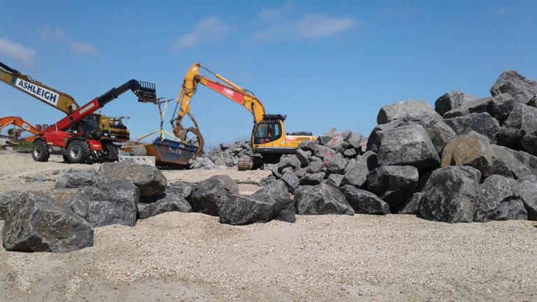 Machinery in full force to shift the rocks from the beach area to form the new sea defences - Courtesy of Southern Water