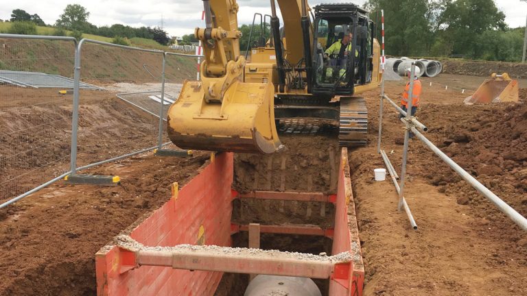 45t excavator laying open cut sections of pipework - Courtesy of Lewis Civil Engineering