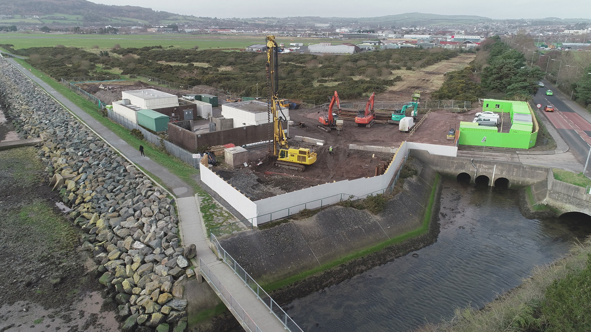 Photo showing considerate painting of hoarding around location for new WwPS as opposed to GRAHAM Construction's corporate green colour - Courtesy of NI Water