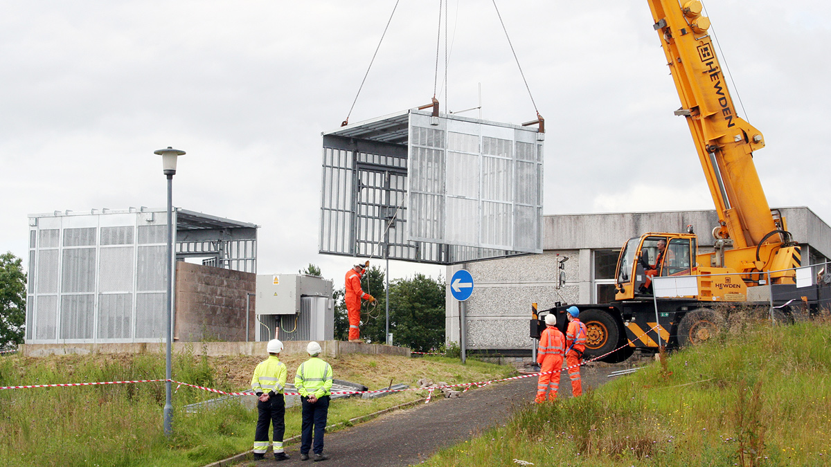A mesh UltraSecure enclosure, measuring 3300mm x 7000mm on plan, being installed in two halves to harden asset protection at a pumping station site