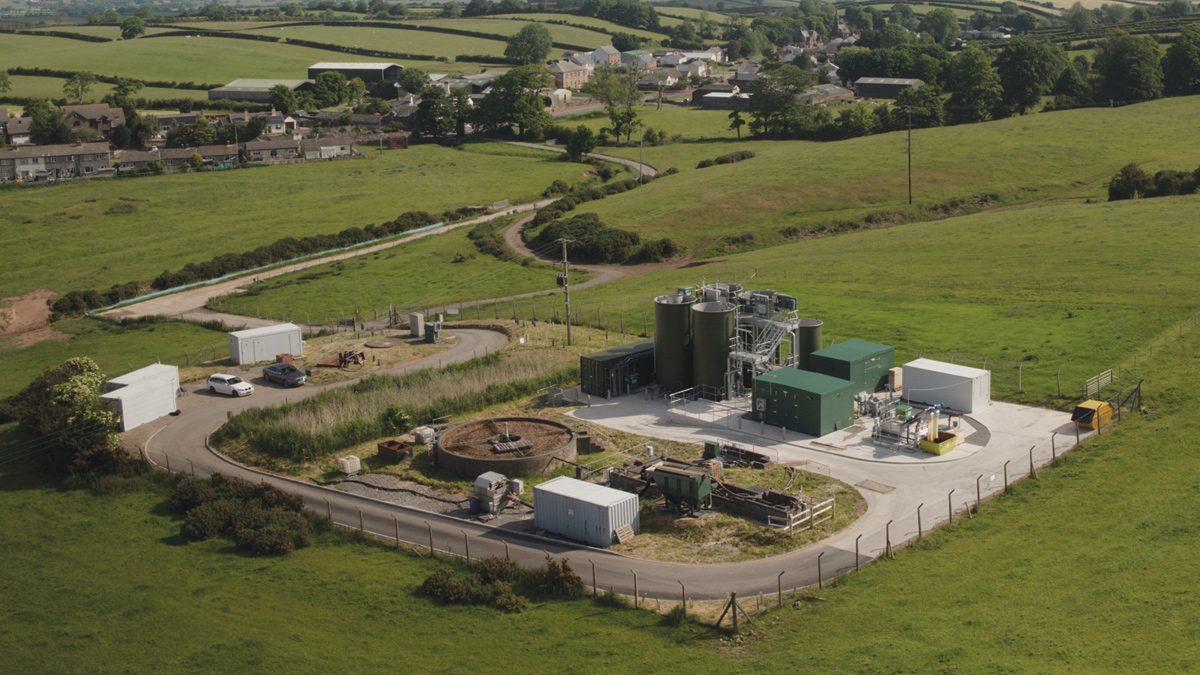 Westnewton WwTW: pre AMP6 traditional treatment assets shown to the left, typical of many small rural WwTWs, replaced with the new Nereda Package Plant and ancillary preliminary treatment stages (screening and degritting) to the right. Access road and village in the background - Courtesy of United Utilities
