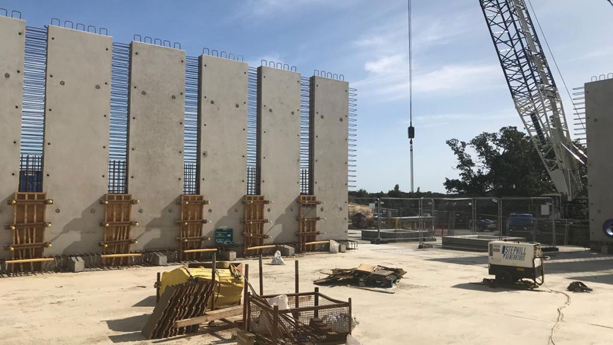 Precast concrete panel walls of Horstead Storage Reservoir being craned into position - Courtesy of @one Alliance